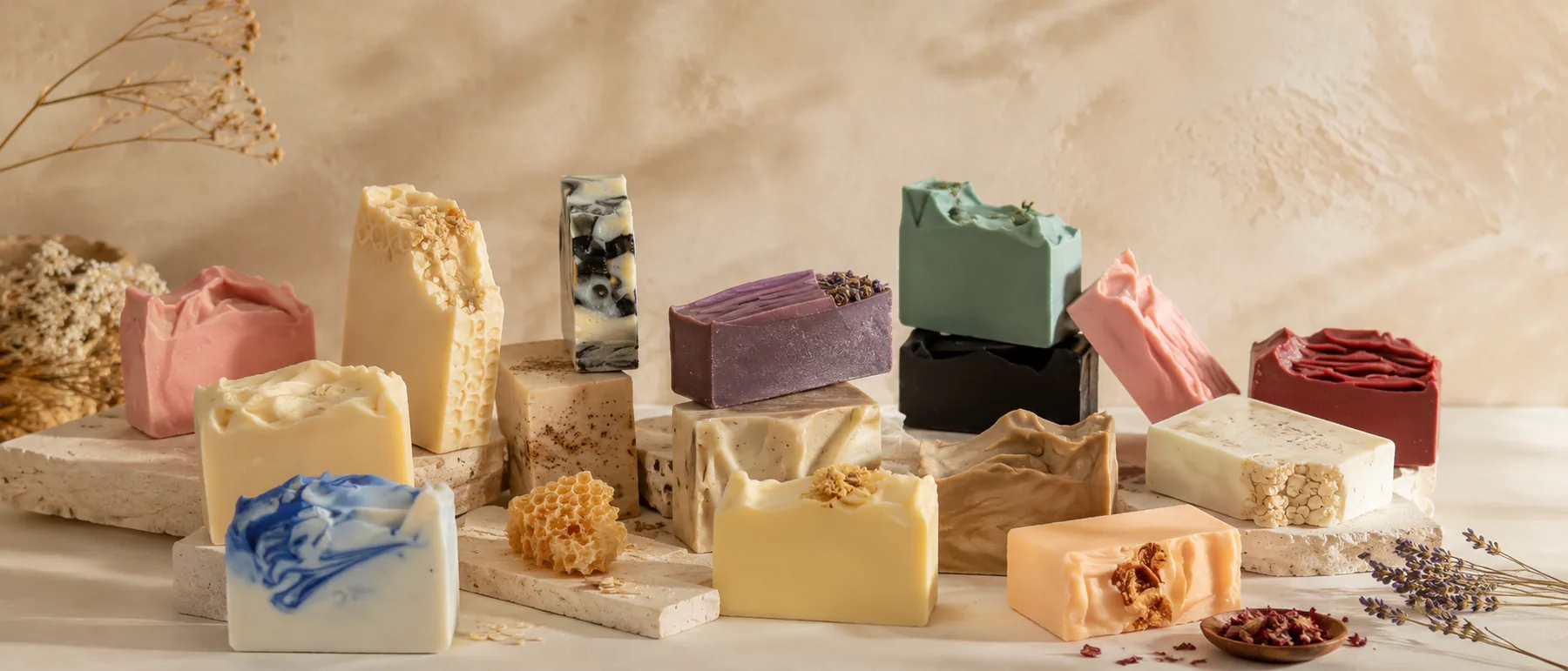 A composed arrangement of GHAM Naturals bars on natural stone plinths